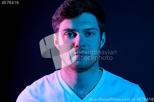 Image of portrait of man over neon lights in dark room