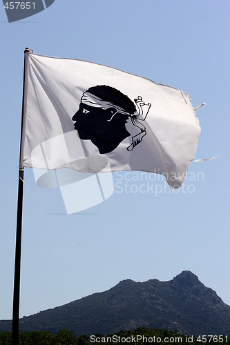 Image of Corsica flag with mountains in background