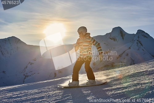 Image of Snowboarder in sun flare, water drops on lens