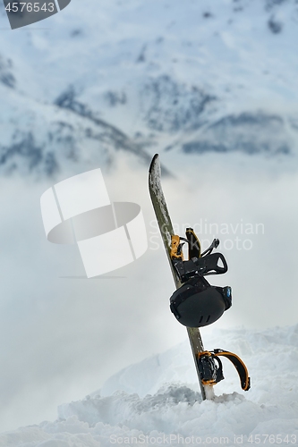 Image of Snowboard high up in the snowy Alps