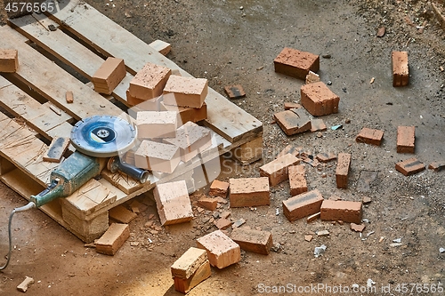 Image of Brick House Construction, Cutting bricks