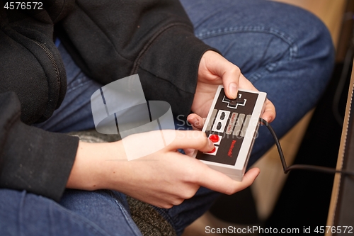 Image of Nintengo NES,playing Super Mario 3