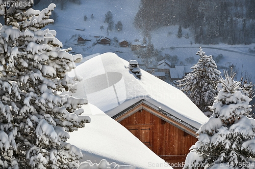 Image of Winter mountain village, roof and chimney covered with snow