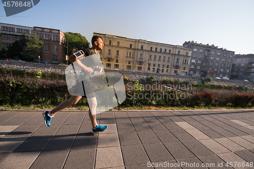 Image of man jogging at sunny morning