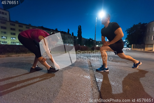 Image of couple warming up and stretching