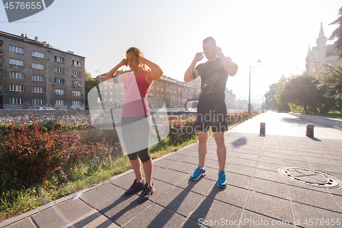 Image of young couple jogging  in the city