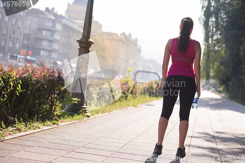 Image of woman jogging at sunny morning