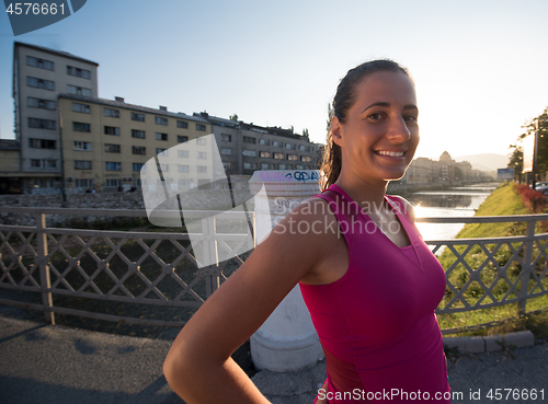 Image of portrait of a jogging woman at sunny morning