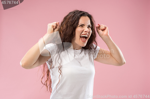 Image of Portrait of an angry woman isolated on a pink background