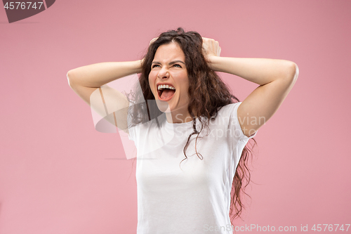 Image of Beautiful woman looking bewildered isolated on pink