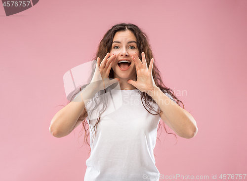 Image of Isolated on pink young casual woman shouting at studio