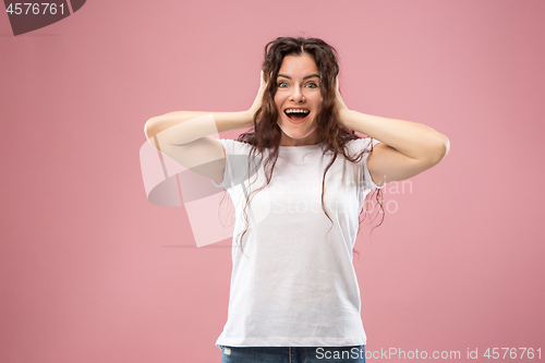 Image of Beautiful woman looking suprised isolated on pink
