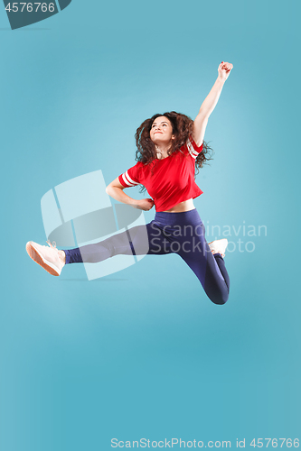 Image of Freedom in moving. Pretty young woman jumping against pink background