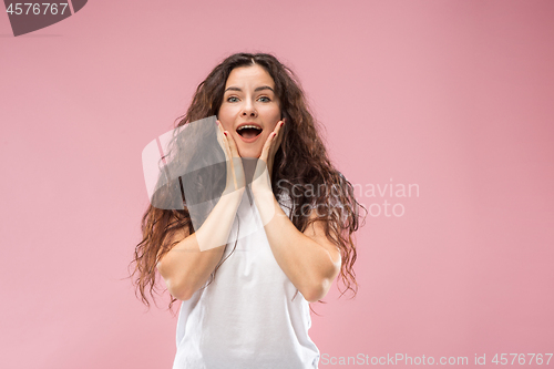Image of Beautiful woman looking suprised isolated on pink