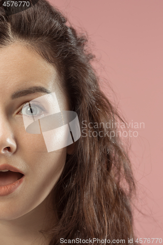 Image of Beautiful woman looking suprised isolated on pink