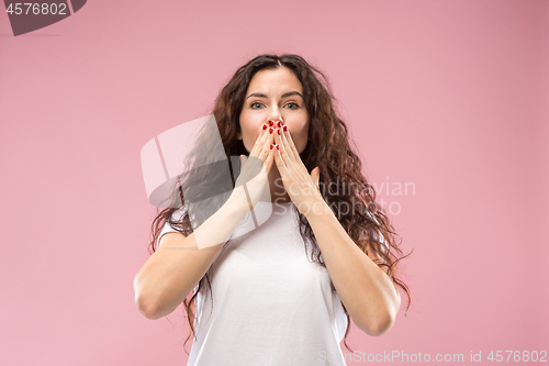 Image of The happy business woman standing and smiling against pink background.