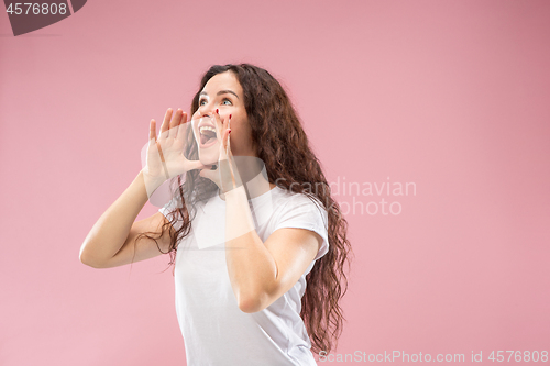 Image of Isolated on pink young casual woman shouting at studio