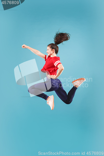 Image of Freedom in moving. Pretty young woman jumping against pink background