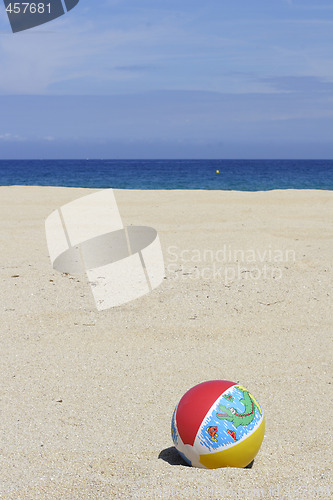 Image of beachball on empty sandy beach