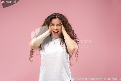 Image of Beautiful woman looking bewildered isolated on pink