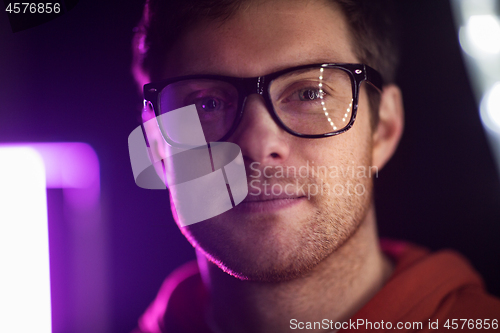 Image of portrait of man in glasses over neon lights