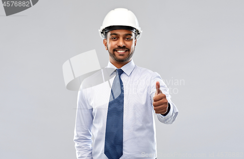 Image of architect or businessman in helmet shows thumbs up