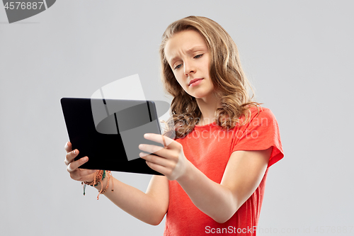 Image of doubting teenage girl with tablet computer