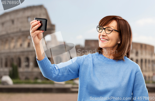 Image of senior woman taking selfie by smartphone