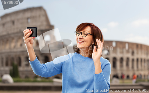 Image of senior woman having video call on smartphone