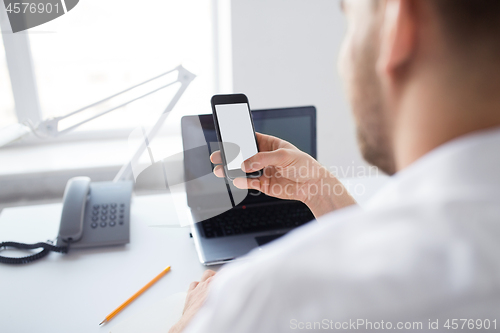 Image of close up of businessman using smartphone at office