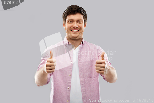 Image of happy young man showing thumbs up