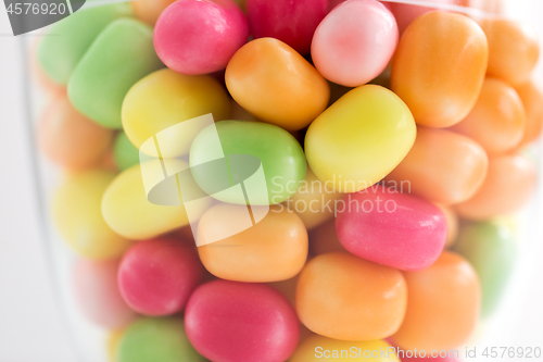 Image of close up of glass jar with colorful candy drops