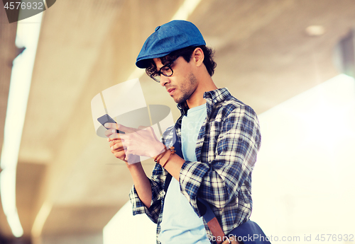 Image of hipster man texting message on smartphone