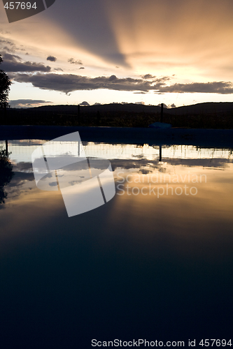 Image of reflection of sunset over swimming pool