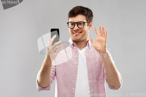 Image of smiling man having video call on smartphone