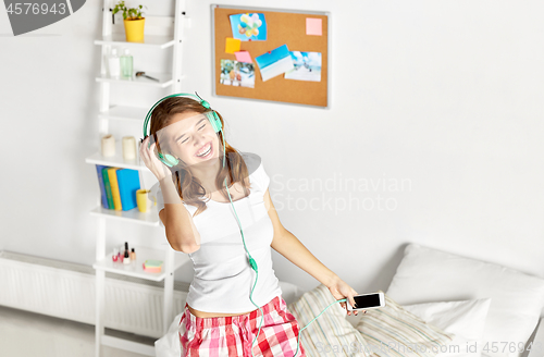 Image of happy woman in headphones having fun at home