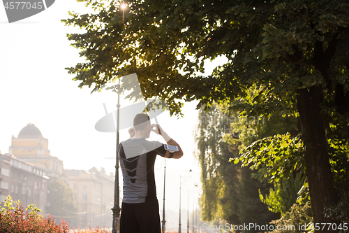 Image of man jogging at sunny morning