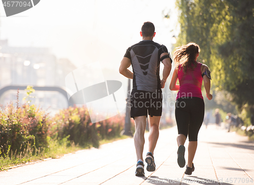 Image of young couple jogging  in the city