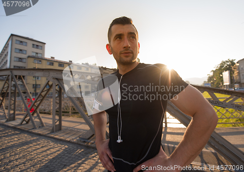 Image of portrait of a jogging man at sunny morning