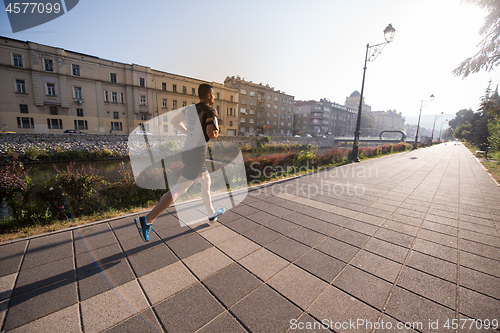 Image of man jogging at sunny morning