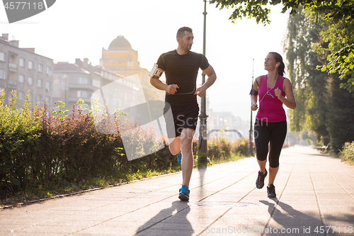 Image of young couple jogging  in the city