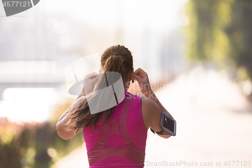 Image of woman jogging at sunny morning