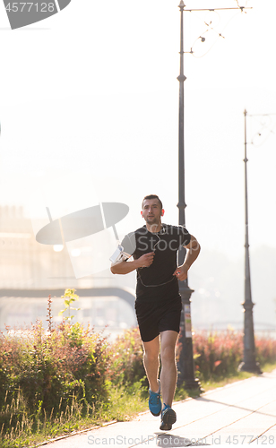 Image of man jogging at sunny morning