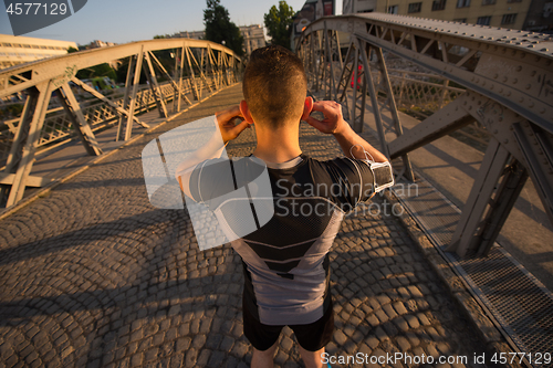 Image of portrait of a jogging man at sunny morning