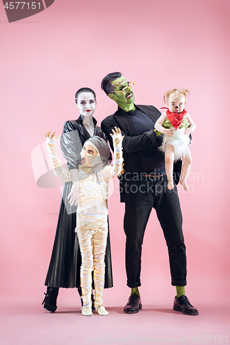 Image of Halloween Family. Happy Father, Mother and Children Girls in Halloween Costume and Makeup