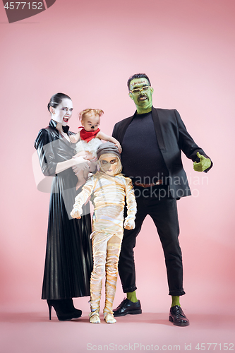 Image of Halloween Family. Happy Father, Mother and Children Girls in Halloween Costume and Makeup