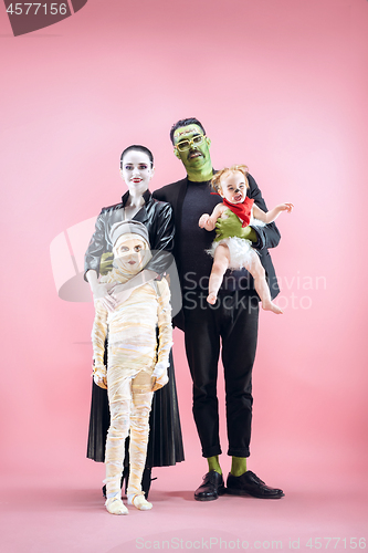 Image of Halloween Family. Happy Father, Mother and Children Girls in Halloween Costume and Makeup