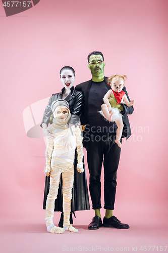 Image of Halloween Family. Happy Father, Mother and Children Girls in Halloween Costume and Makeup