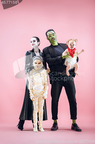 Image of Halloween Family. Happy Father, Mother and Children Girls in Halloween Costume and Makeup