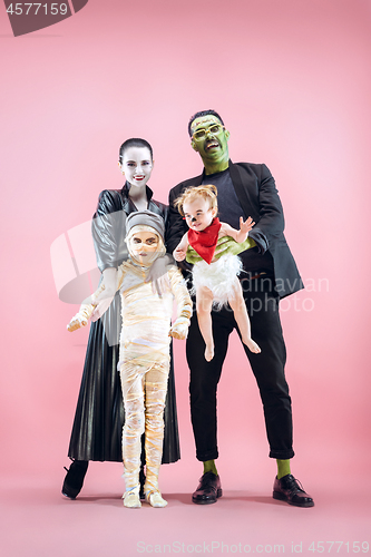 Image of Halloween Family. Happy Father, Mother and Children Girls in Halloween Costume and Makeup